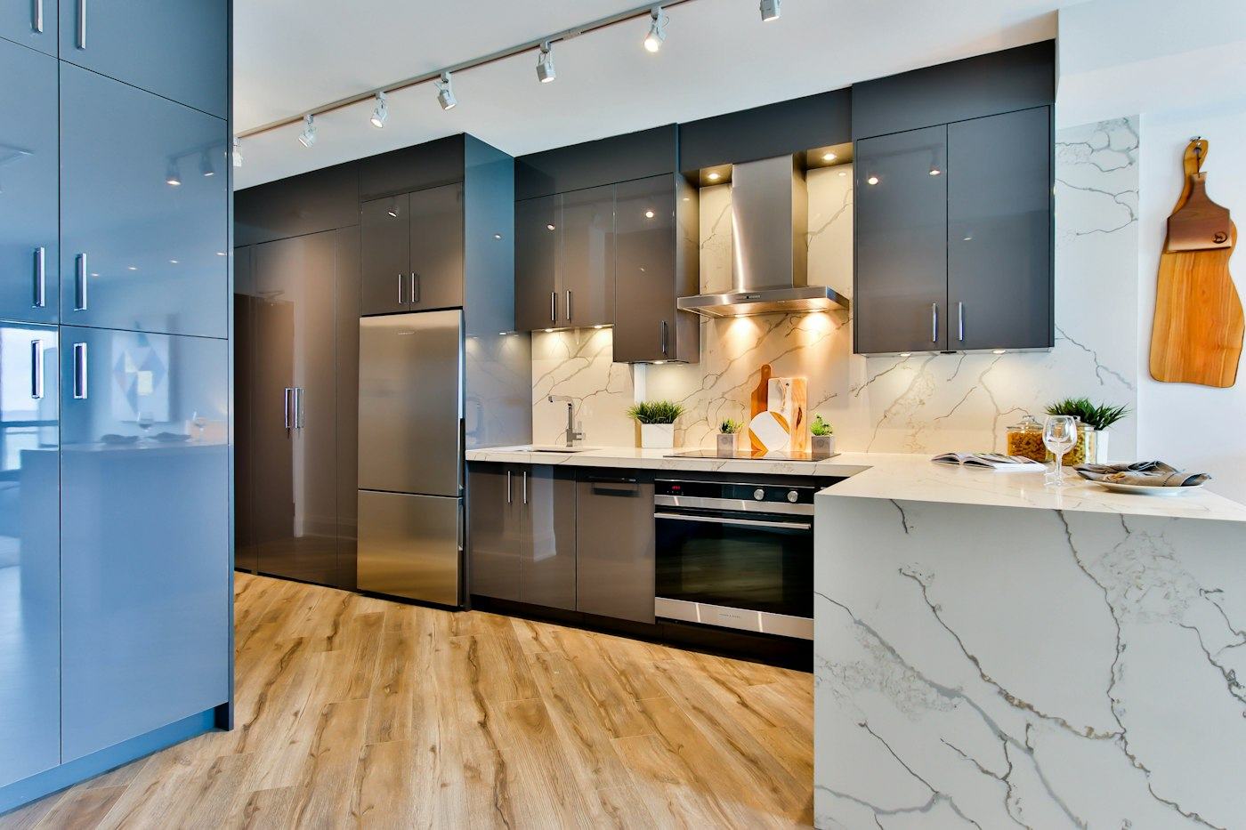 Kitchen with dark cabinets and marble counters