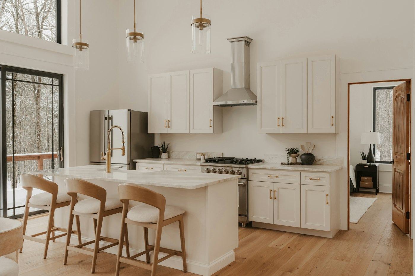 Bright kitchen with white cabinets and a wood island