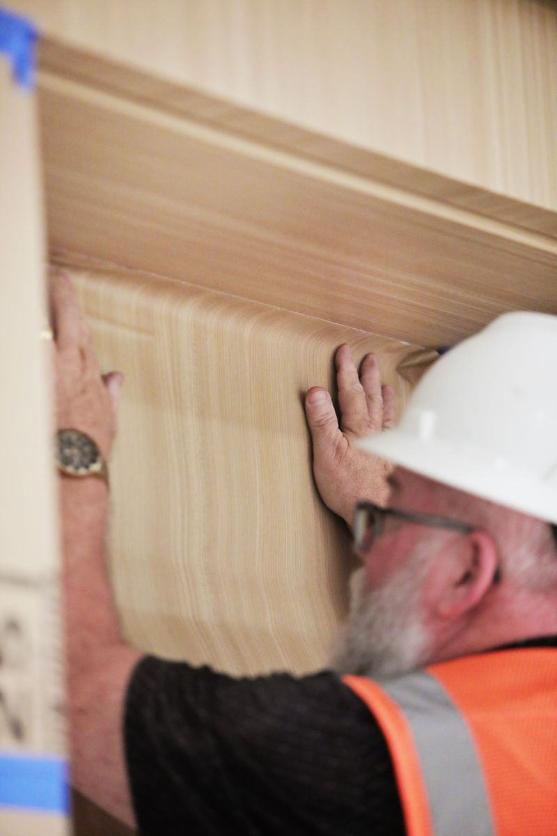 Installer applying woodgrain architectural film