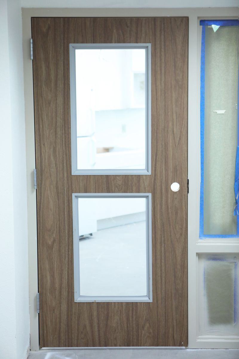 Door wrapped in walnut woodgrain architectural film